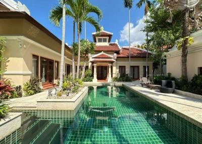 Luxurious pool with a view of the beautiful villa and tropical landscaping