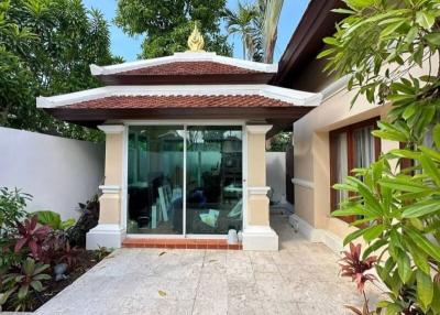Elegant home entrance with glass doors and traditional roof
