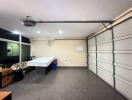 Spacious garage with tiled floor and storage cabinets