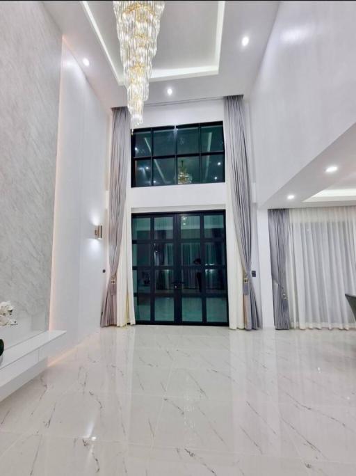 Luxurious foyer with high ceilings and marble floors