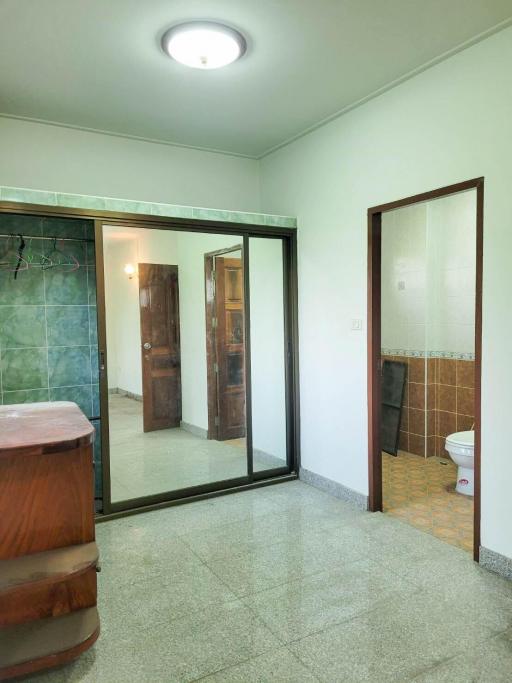 Bright bathroom with glass shower enclosure and marble flooring