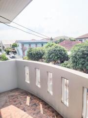 Spacious balcony with a view of a residential neighborhood