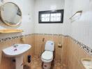 Compact bathroom with tiled flooring and walls, equipped with a sink, toilet, and mirror