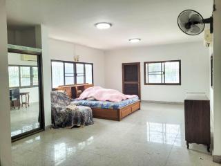 Spacious bedroom with large bed and tile flooring