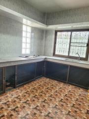 Spacious kitchen with natural light and tile flooring