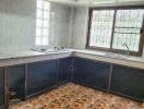 Spacious kitchen with natural light and tile flooring