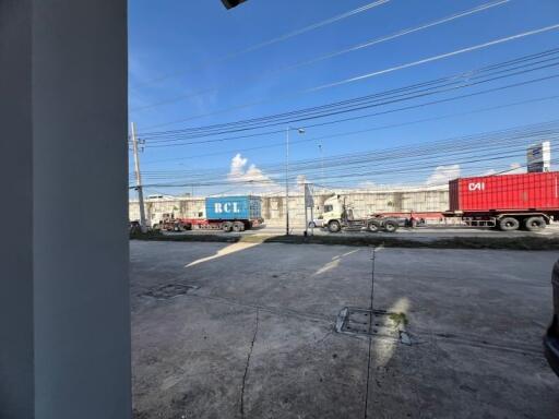 View from property showing industrial area with trucks and containers