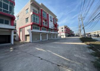 Exterior view of modern residential building with spacious parking lot