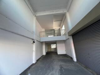Spacious industrial building interior with mezzanine and large rolling door