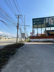Outdoor street view with power lines and billboards in a commercial area