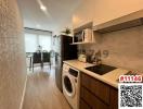 Compact modern kitchen with integrated appliances and adjacent dining area