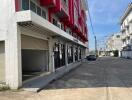 Exterior view of a modern apartment building with retail spaces on the ground floor