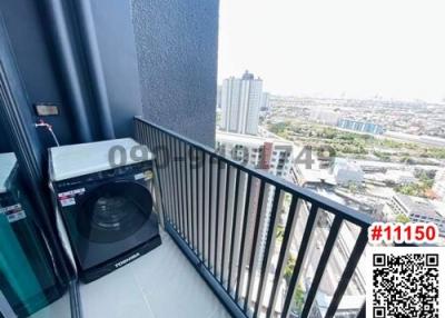 Balcony with city view and a washing machine