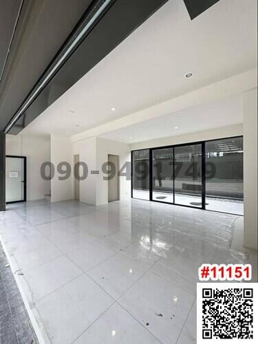 Spacious unfurnished building interior with large windows and glossy tiled flooring