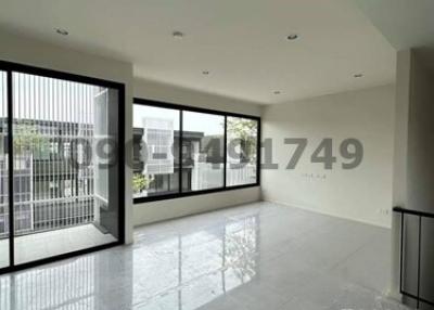 Spacious and bright empty room with large windows and glossy tiled flooring in a modern building