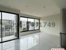 Spacious and bright empty room with large windows and glossy tiled flooring in a modern building