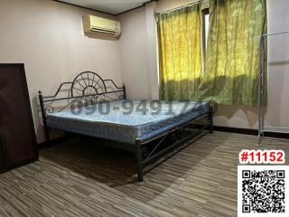 Spacious bedroom with large bed and air conditioning unit