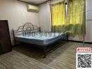 Spacious bedroom with large bed and air conditioning unit