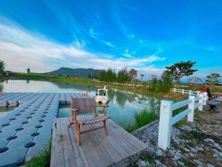 Peaceful lakeside outdoor wooden deck with a chair and scenic view