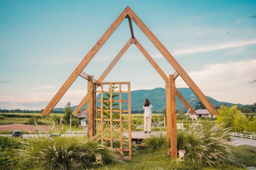 Modern wooden A-frame structure in a scenic countryside outdoor setting