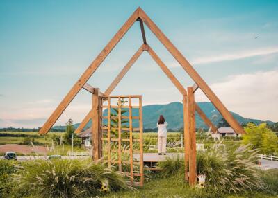 Modern wooden A-frame structure in a scenic countryside outdoor setting