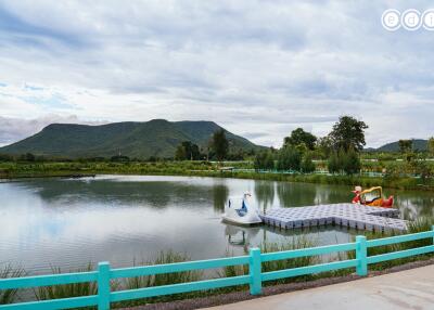 Serene lake view with paddle boats and a mountain backdrop
