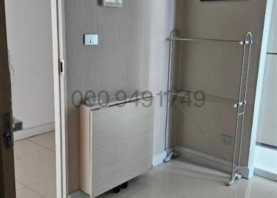 Modern entryway in apartment with sleek flooring and cloth rack