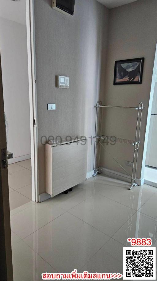 Modern entryway in apartment with sleek flooring and cloth rack