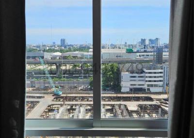 Cityscape view from a high-rise apartment window with clear skies