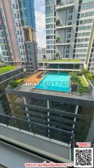 High-rise apartment view overlooking a swimming pool and courtyard