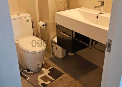 Compact modern bathroom with wall-mounted sink and toilet