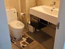 Compact modern bathroom with wall-mounted sink and toilet