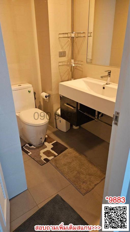 Compact modern bathroom with wall-mounted sink and toilet