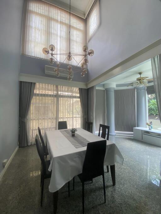 Spacious dining room with high ceiling and ample natural light