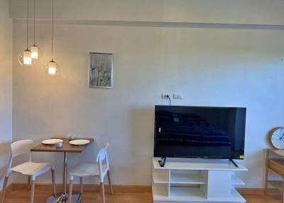 Modern living room with dining area and flat-screen TV