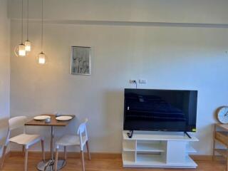 Modern living room with dining area and flat-screen TV