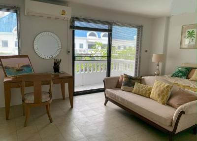 Cozy living room with natural light and balcony access