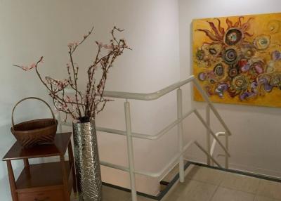 Bright hallway with decorative painting and vase