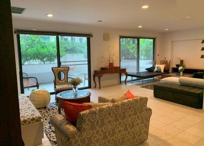 Spacious living room with large windows and comfortable seating