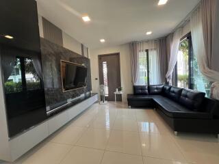 Spacious and modern living room with large L-shaped sofa and flat-screen TV