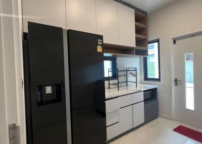 Modern kitchen with black appliances and white cabinets