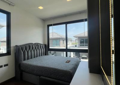 Modern bedroom with abundant natural light and sleek design