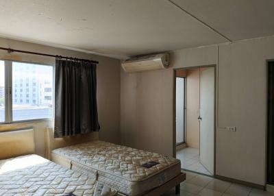 Spacious bedroom with natural light and air conditioning