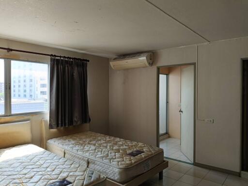 Spacious bedroom with natural light and air conditioning