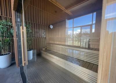 Spacious balcony with wooden bench seating and bamboo plants