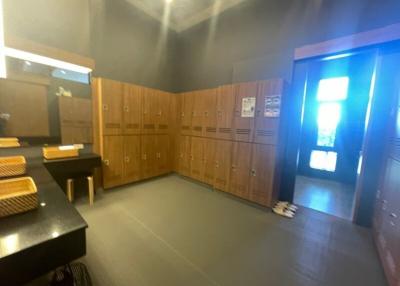 Spacious locker room with wooden lockers and seating area