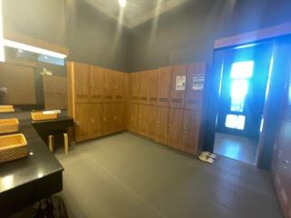 Spacious locker room with wooden lockers and seating area