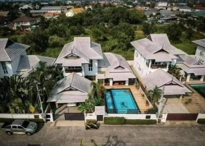 Aerial view of a suburban residential community with pool