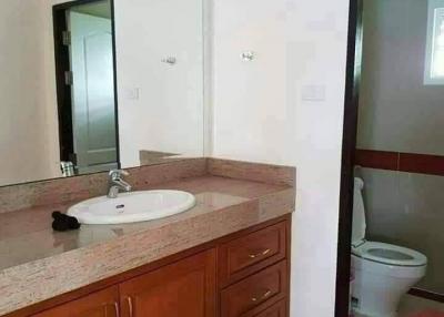 Spacious bathroom with modern sink and wooden cabinets