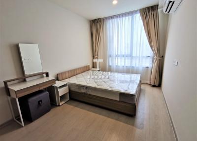 Spacious bedroom with modern furniture and ample natural light